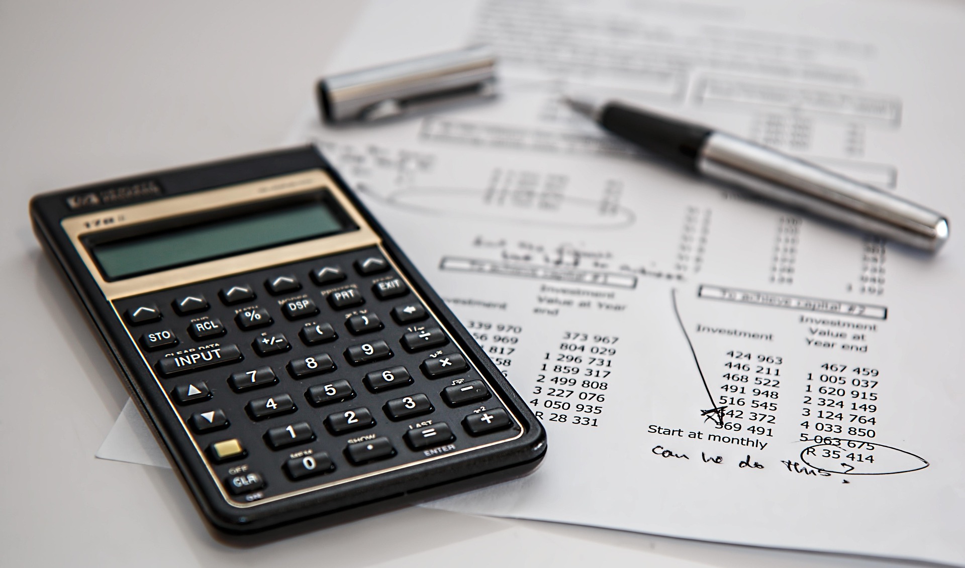 Calculator and financial documents representing costs of document chaos