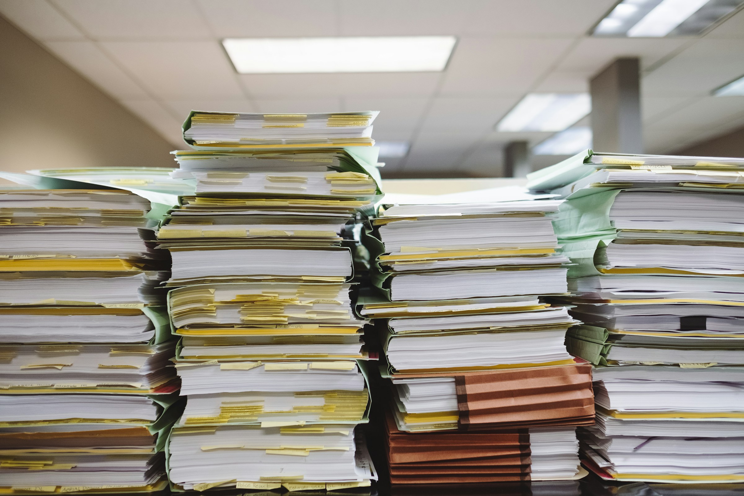 Overwhelming stacks of documents representing manual data entry work